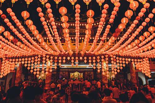 pub people gathering under orange paper lanterns glow